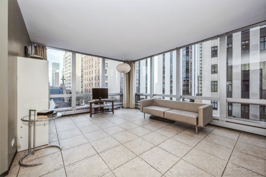 1300 North Astor Street, Unit 6B Chicago, IL 60610 - Photo 2 of 10 a living room with furniture and large windows