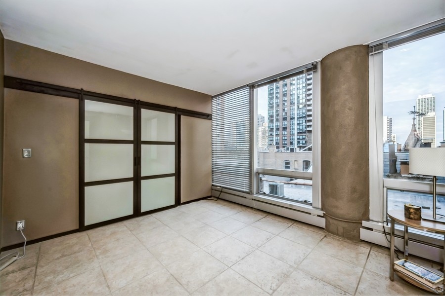 1300 North Astor Street, Unit 6B Chicago, IL 60610 - Photo 9 of 10 a view of a big room with windows and cabinet
