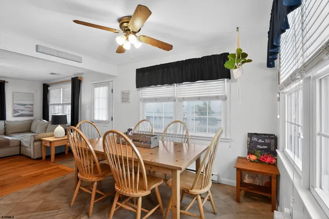 a view of a dining room with furniture wooden floor and chandelier