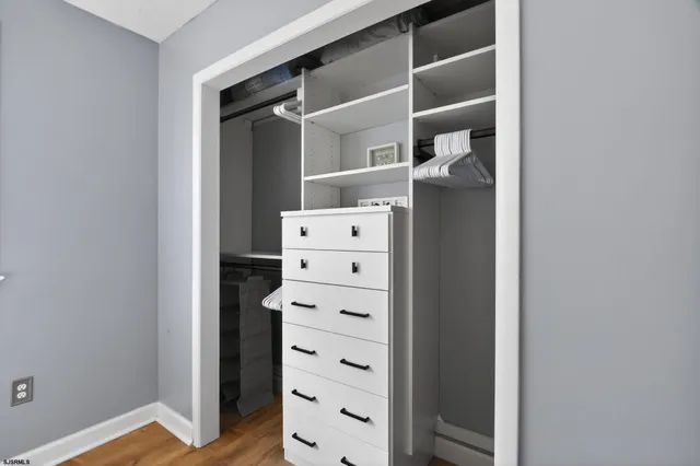 a view of walk in closet with empty racks