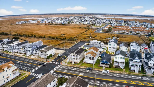 a view of a building with cars parked on the road