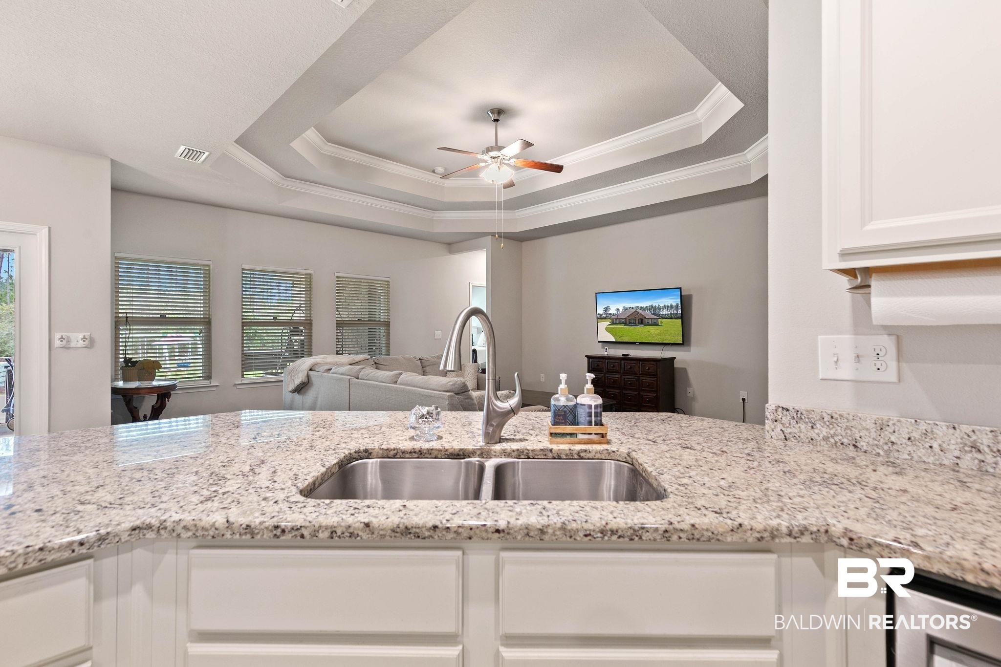 12750 B Jenkins Pit Road Daphne, AL 36527 - Photo 89 of 89 Kitchen with open floor plan, ornamental molding, a ceiling fan, white cabinets, and light stone counters