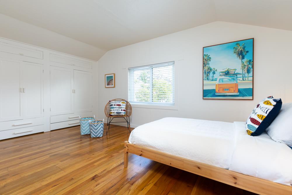 209 Fanmar Way Capitola, CA 95010 - Photo 24 of 31 a bedroom with a bed and wooden floor