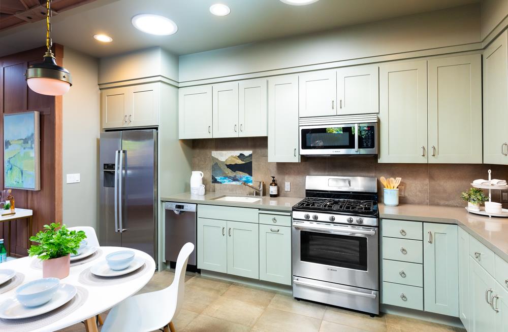 209 Fanmar Way Capitola, CA 95010 - Photo 9 of 31 a kitchen with stainless steel appliances a white table and chairs