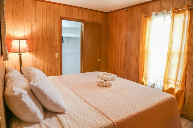 a bedroom with a bed and a lamp on table