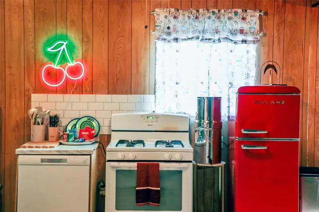a kitchen with a stove and a refrigerator