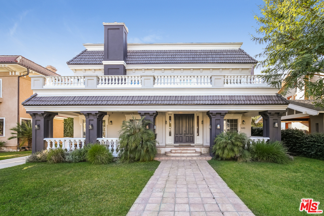 1643 Buckingham Road Los Angeles, CA 90019 - Photo 1 of 26 a front view of a house with a garden