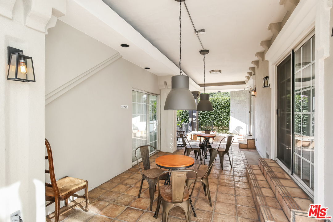 1643 Buckingham Road Los Angeles, CA 90019 - Photo 18 of 26 a view of a dining room with furniture a chandelier and wooden floor