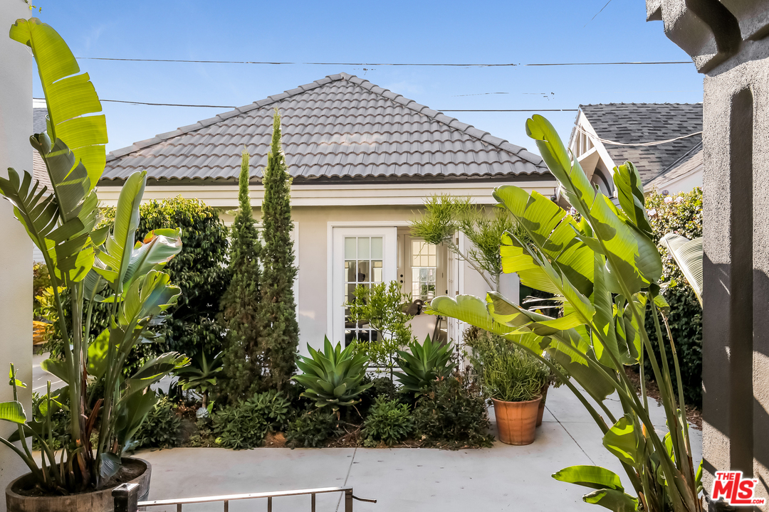 1643 Buckingham Road Los Angeles, CA 90019 - Photo 19 of 26 a front view of a house with a yard