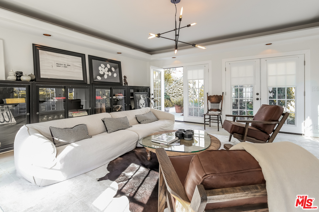 1643 Buckingham Road Los Angeles, CA 90019 - Photo 20 of 26 a living room with furniture ceiling fan and a window