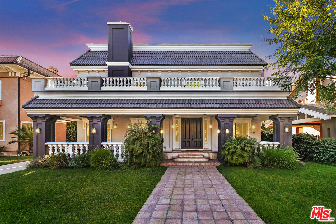 1643 Buckingham Road Los Angeles, CA 90019 - Photo 22 of 26 a front view of a house with a garden and plants