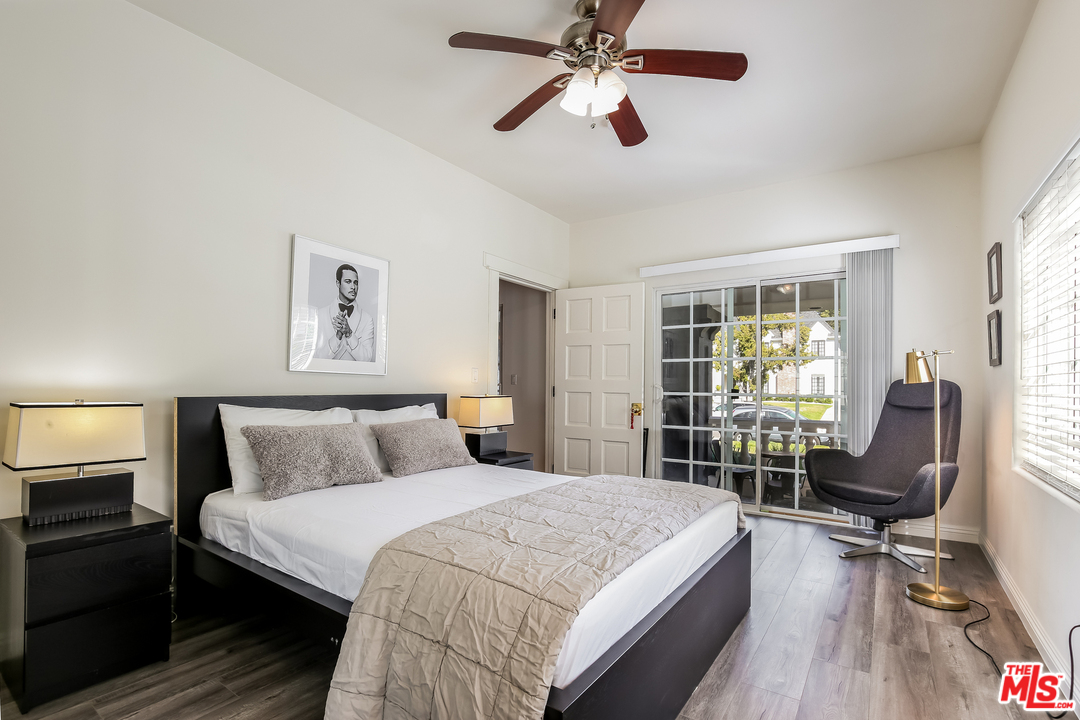 1643 Buckingham Road Los Angeles, CA 90019 - Photo 6 of 26 a bedroom with a bed and a chair