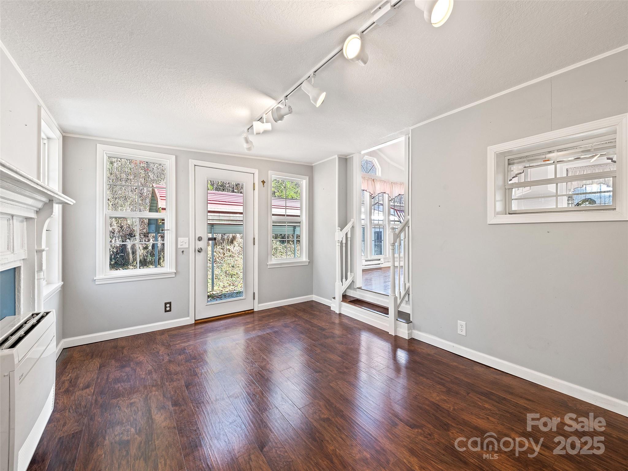 93 Merry Way Clyde, NC 28721 - Photo 14 of 24 an empty room with wooden floor and windows