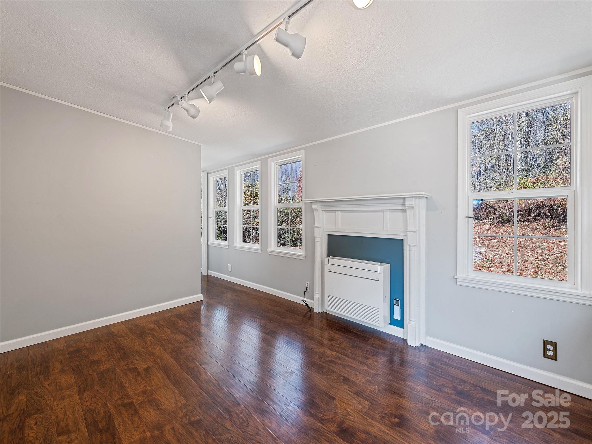 93 Merry Way Clyde, NC 28721 - Photo 15 of 24 a view of an empty room with a window and wooden floor