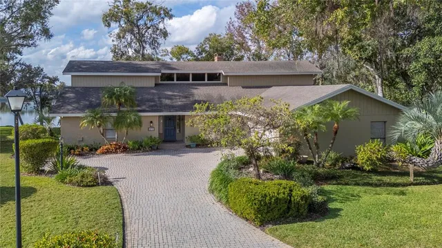 a living room with furniture a fireplace and a large window