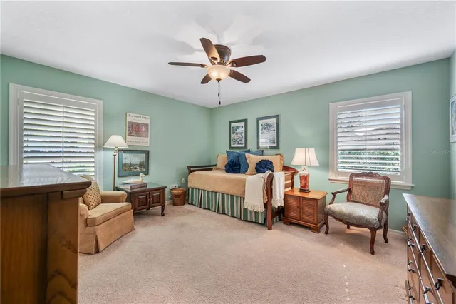 a front view of a house with a yard and potted plants