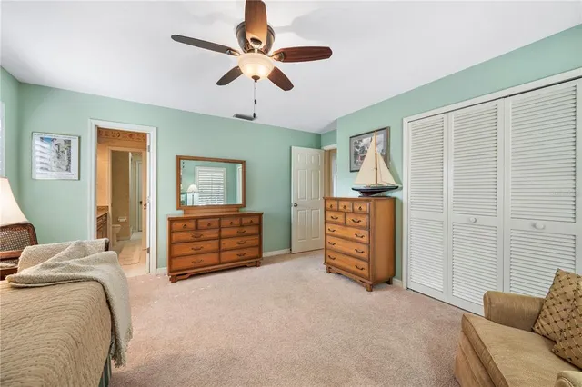 a front view of a house with a yard and potted plants