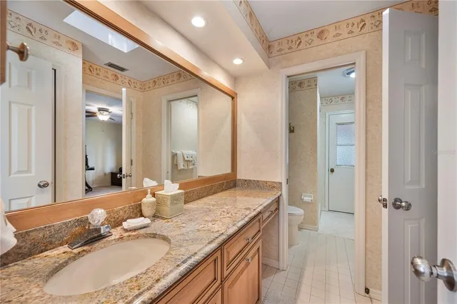 a view of a house with garden and a bench