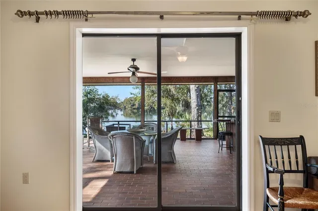 an aerial view of a house with a yard and lake view