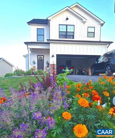 a front view of house with yard and flowers