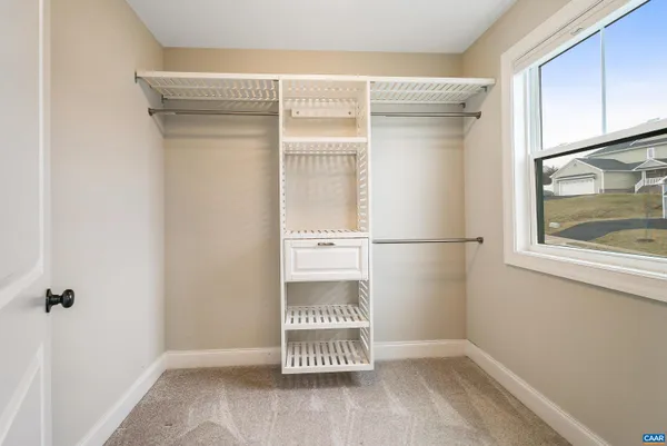 a view of an empty room and closet area
