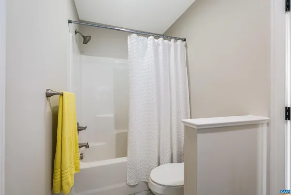 a bathroom with a toilet sink vanity and mirror