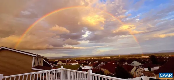 a view of kitchen with dining area refrigerator and wooden floor