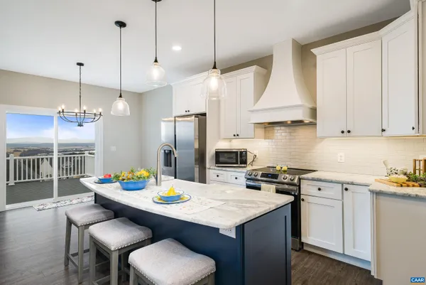 a kitchen with stainless steel appliances granite countertop a sink refrigerator and cabinets