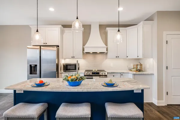 a living room with kitchen island furniture and a potted plant