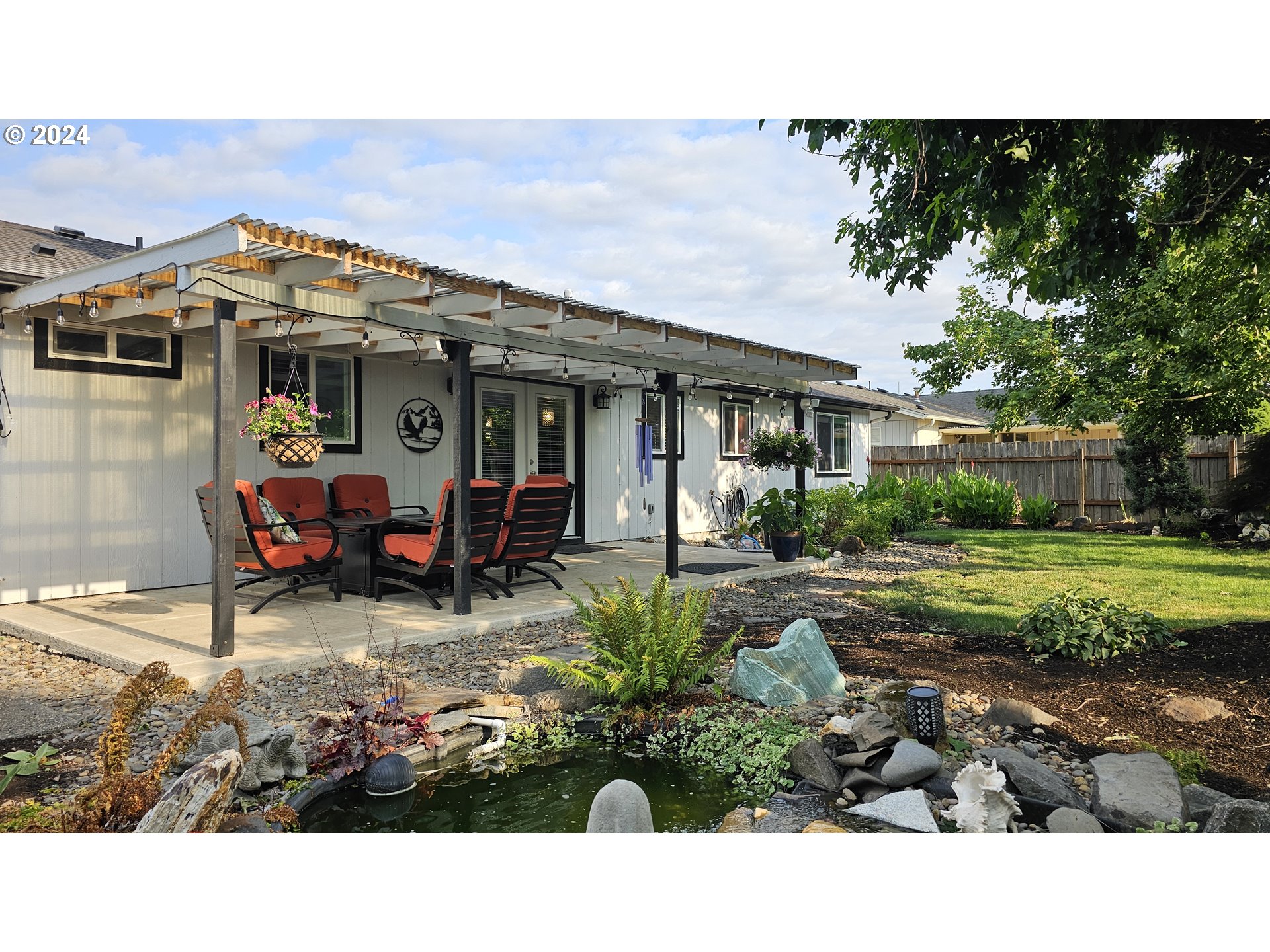 2168 15th Street Springfield, OR 97477 - Photo 24 of 43 a view of a house with backyard sitting area and garden