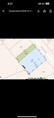 a view of a street with a bench and trees around