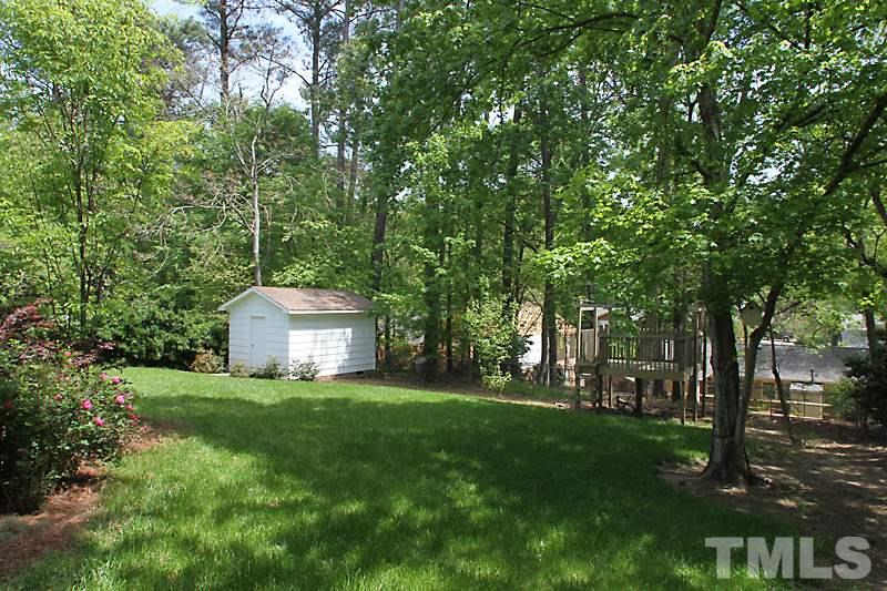 905 Tyrrell Road Raleigh, NC 27609 - Photo 11 of 13 a view of a house with a big yard and large trees