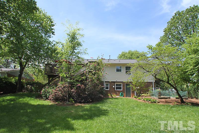 905 Tyrrell Road Raleigh, NC 27609 - Photo 12 of 13 a view of a house with a big yard and potted plants and large trees