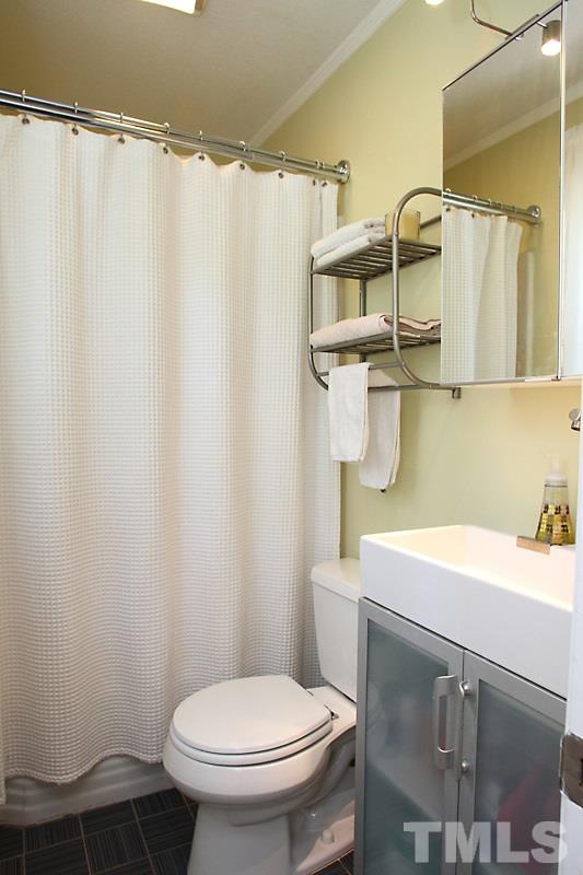 905 Tyrrell Road Raleigh, NC 27609 - Photo 8 of 13 a bathroom with a sink toilet and shower