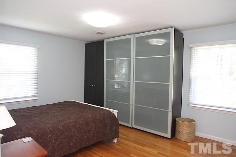 905 Tyrrell Road Raleigh, NC 27609 - Photo 9 of 13 a bedroom with a bed and a window