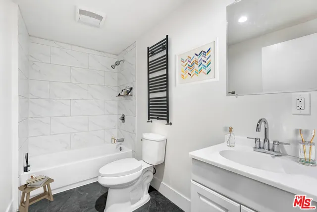 a bathroom with a sink a toilet and a bathtub