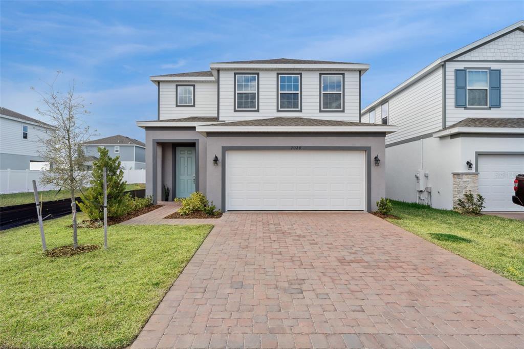7028 Rolling Leaf Road Groveland, FL 34736 - Photo 1 of 1 a front view of a house with a yard and garage