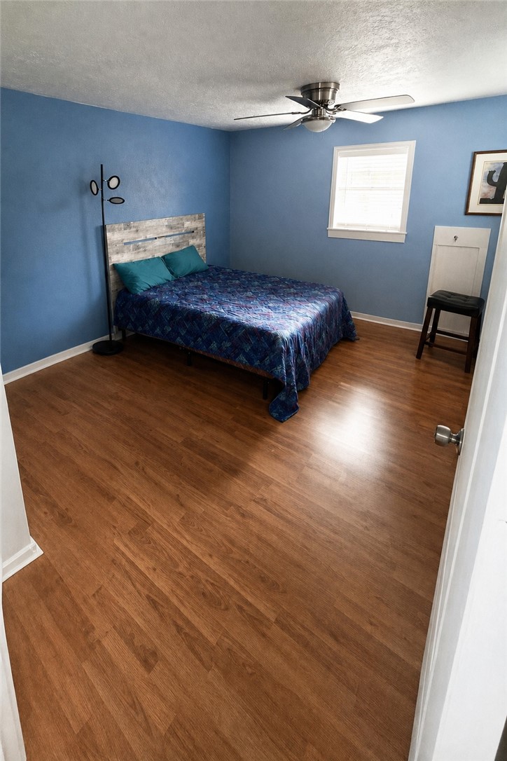 421 South Commerce Street Centerville, TX 75833 - Photo 10 of 23 a bedroom with two beds and a desk