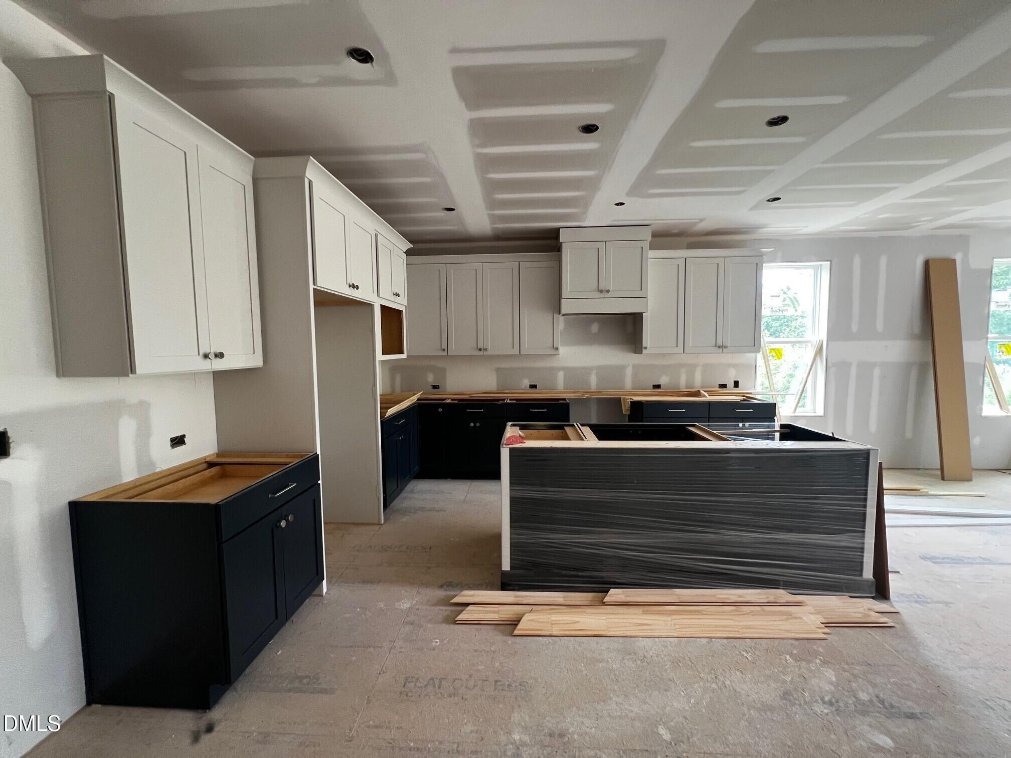 1675 Terry Road Durham, NC 27712 - Photo 3 of 23 a kitchen with kitchen island granite countertop a sink cabinets and stainless steel appliances