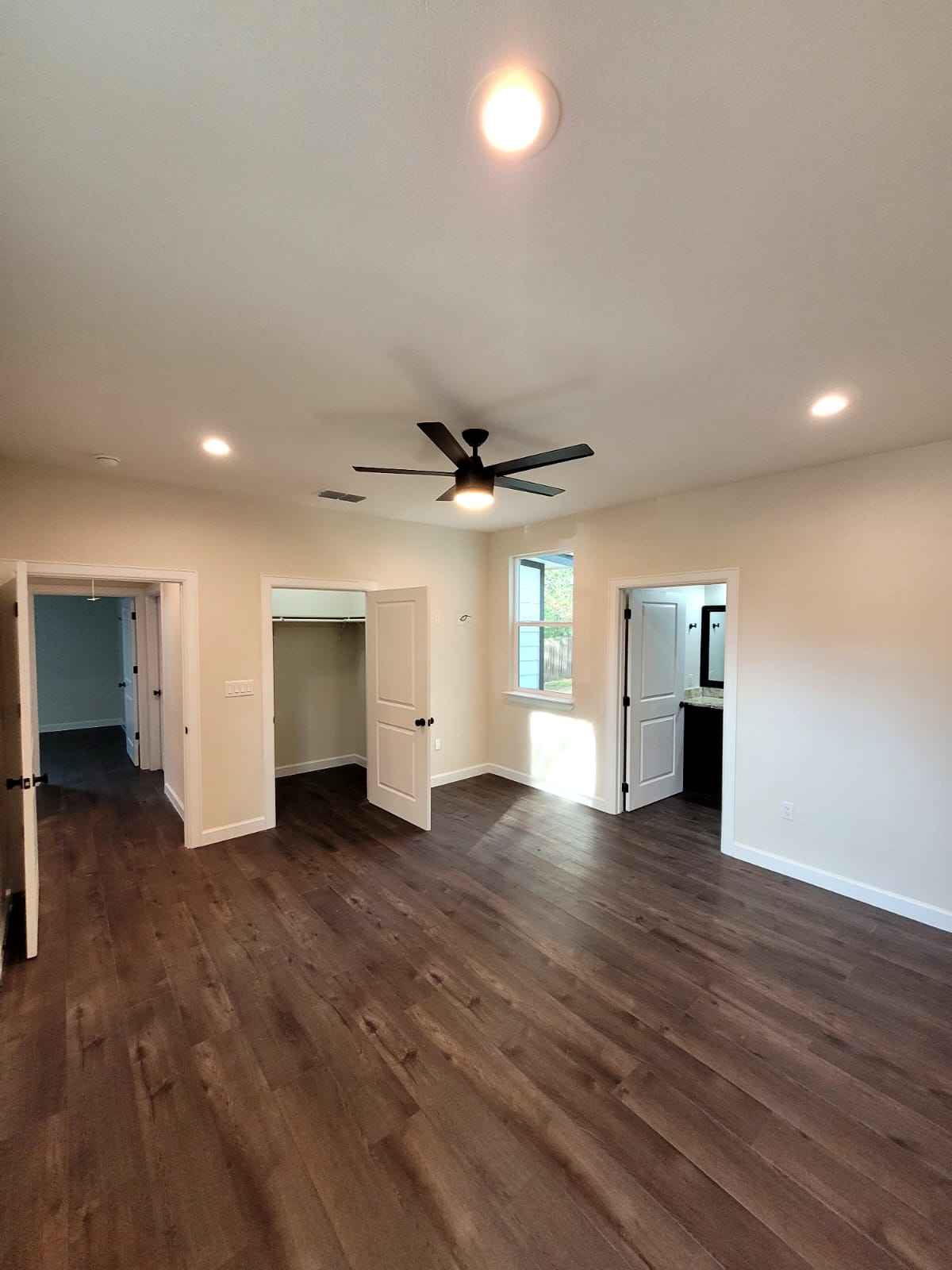 750 South Main Street Lockhart, TX 78644 - Photo 20 of 31 Unfurnished bedroom featuring a closet, dark wood-style floors, recessed lighting, and a ceiling fan