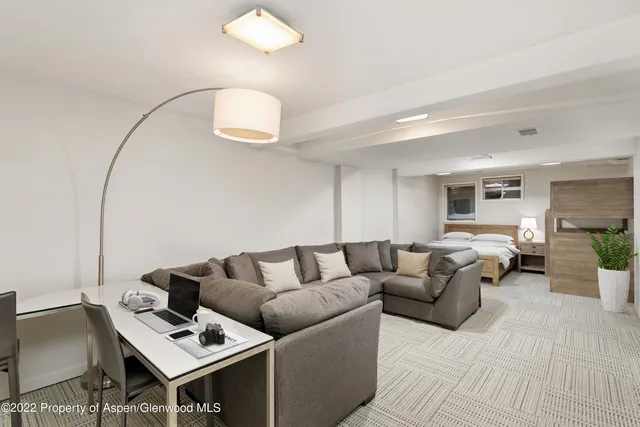 a bedroom with two beds and potted plant