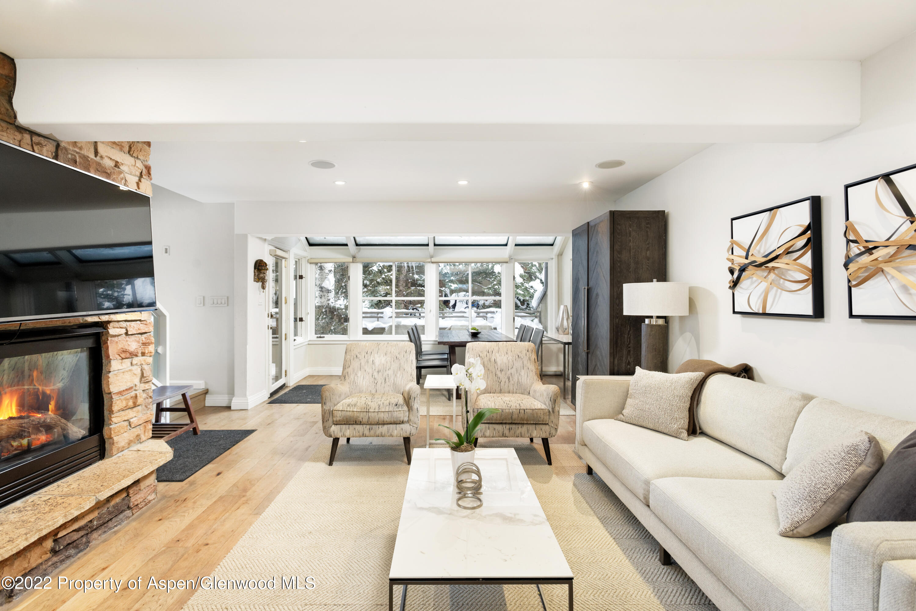100 North 8th Street, Unit 20 Aspen, CO 81611 - Photo 3 of 18 a living room with furniture large window and a fireplace