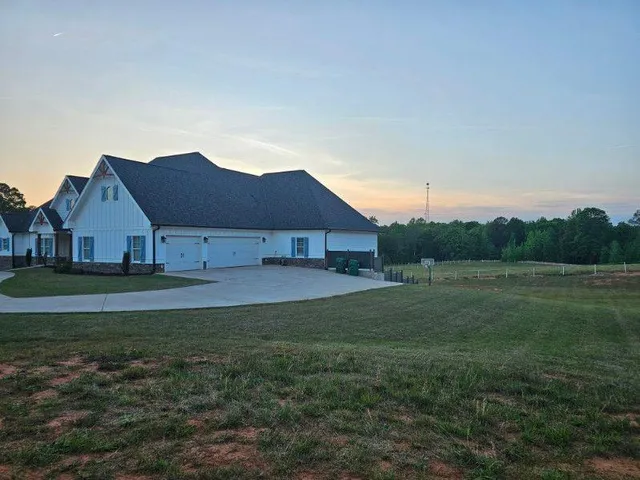 a view of a swimming pool with a patio and plants