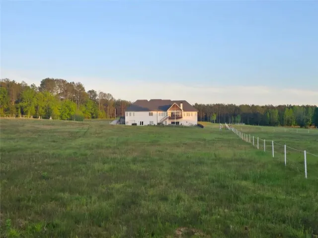 a large kitchen with kitchen island a counter space a sink appliances and cabinets