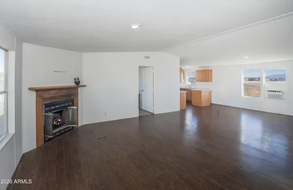 a large living room with wooden floors and a fireplace