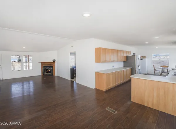 a living room with furniture and view of kitchen