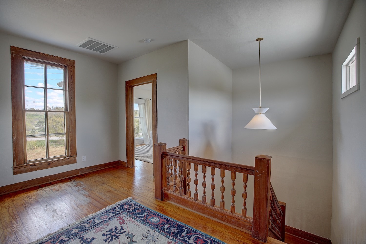 11228 Parsons Road Manor, TX 78653 - Photo 27 of 40 a view of an empty room with wooden floor and a window
