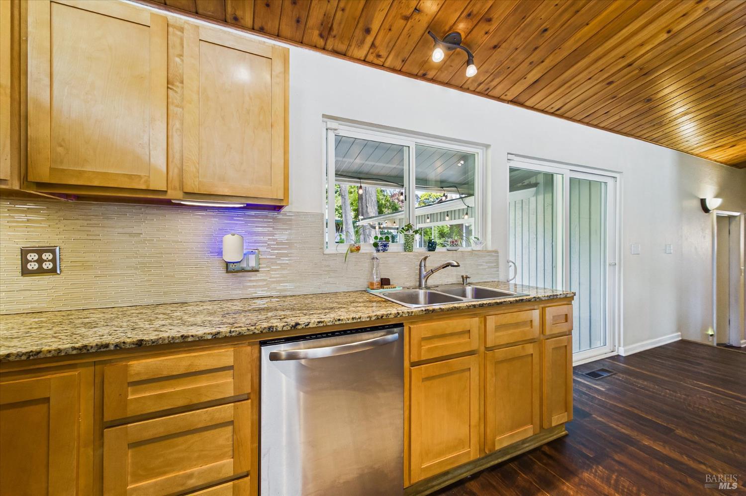 2305 Harris Street Eureka, CA 95503 - Photo 13 of 31 a kitchen with granite countertop cabinets stainless steel appliances a sink and wooden floor