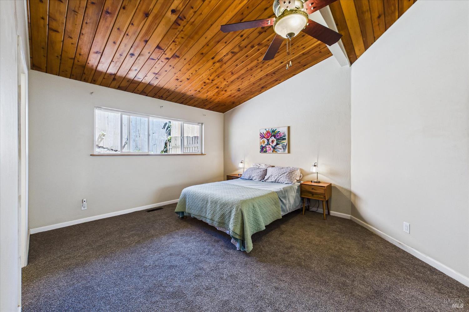 2305 Harris Street Eureka, CA 95503 - Photo 17 of 31 a bedroom with a bed and a chandelier