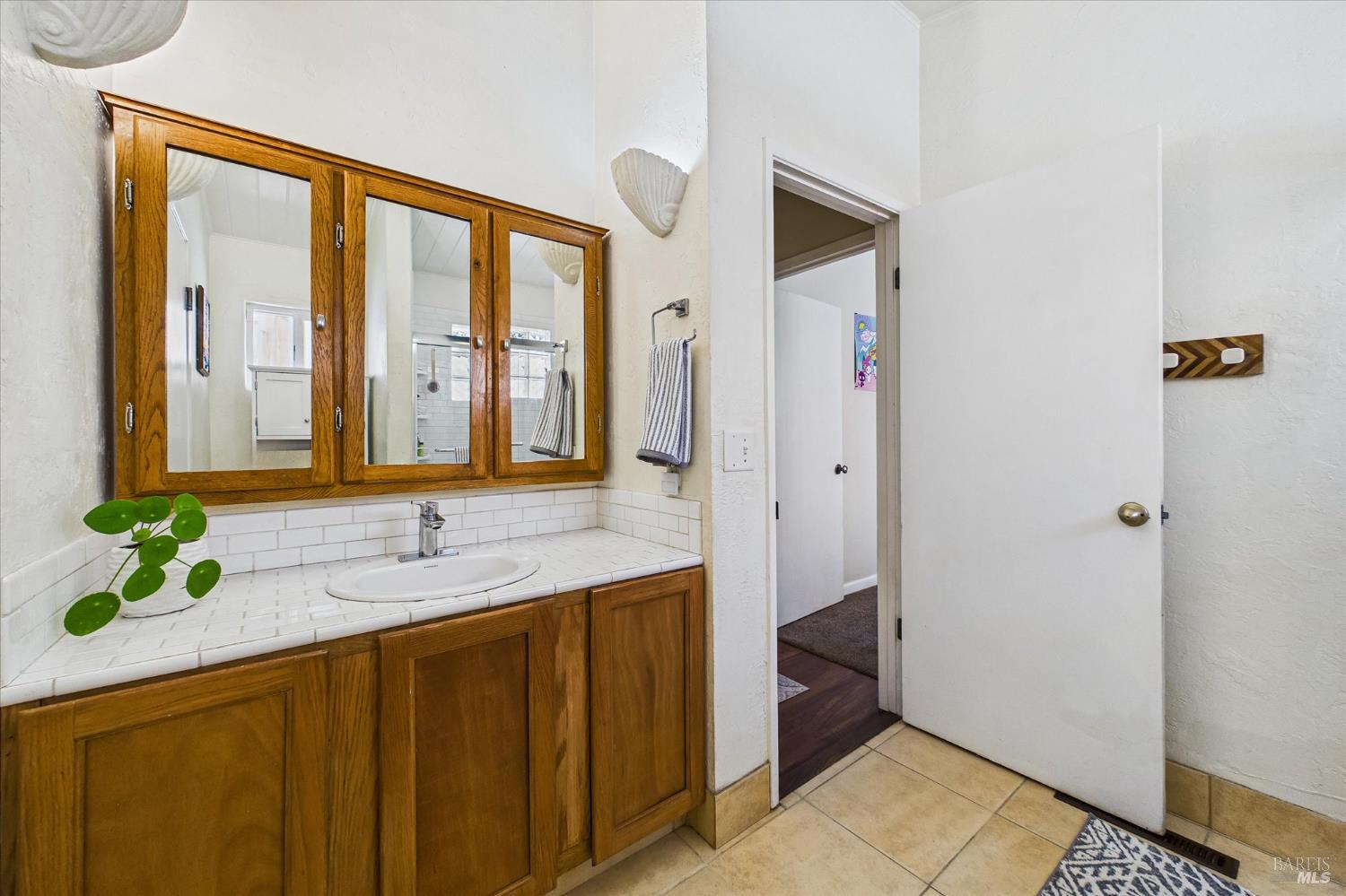2305 Harris Street Eureka, CA 95503 - Photo 19 of 31 a bathroom with a granite countertop sink and a mirror